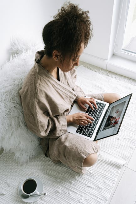 Person working on a laptop looking tired and in need of a break
