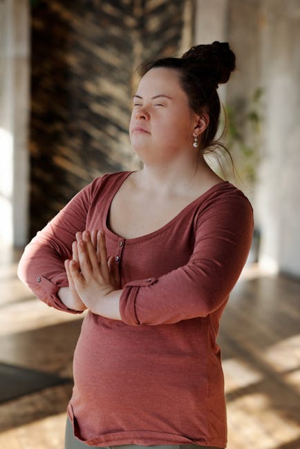 Woman relaxing in a peaceful yoga pose in a living room at sunset